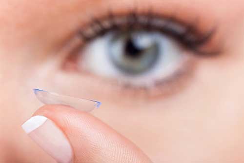 Close up of woman putting in contact lens