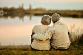 Older couple sitting on lake