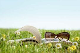 Sunglasses on book in meadow
