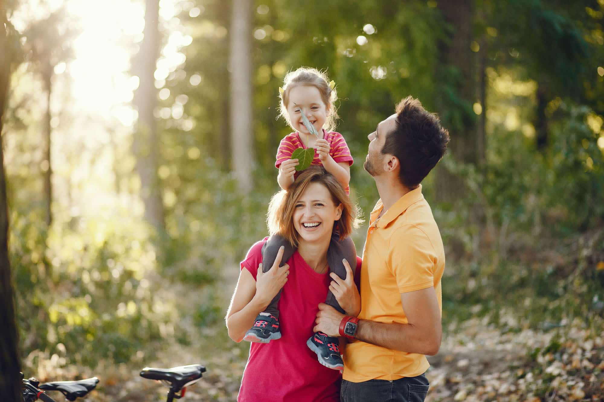 An active family takes a break together while enjoying a bike ride.