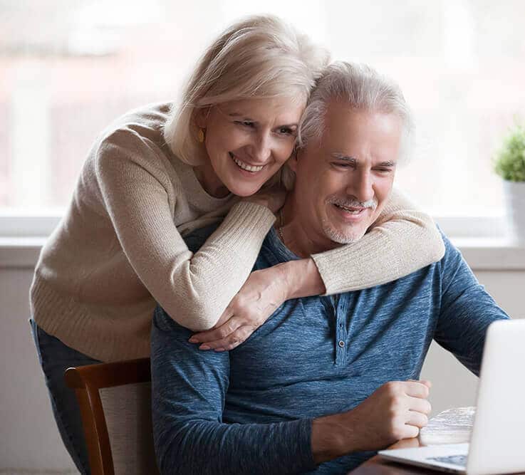 Mature couple looking at laptop together