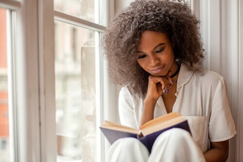 young woman reading a book without glasses